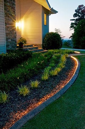 Outdoor lighting project- rope light within flowerbed curbing